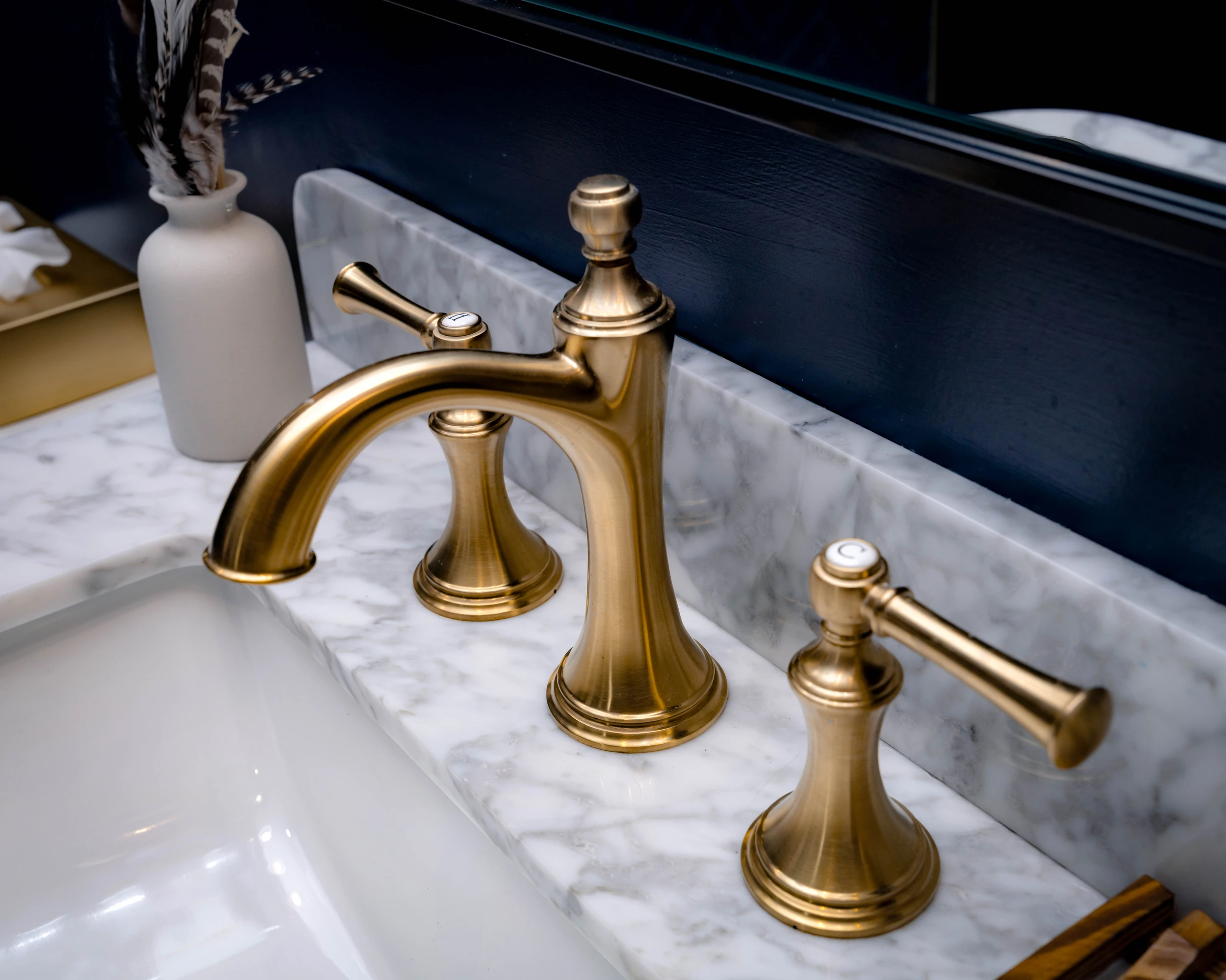 Luxury bathroom with gold faucet in The Highliner